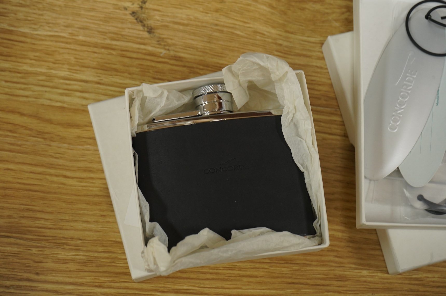 Five boxed British Airways Concorde branded promotional items including; a sterling silver trinket box by Links of London, a hip flask, a bottle opener, a leather credit card holder, and three unused luggage labels
